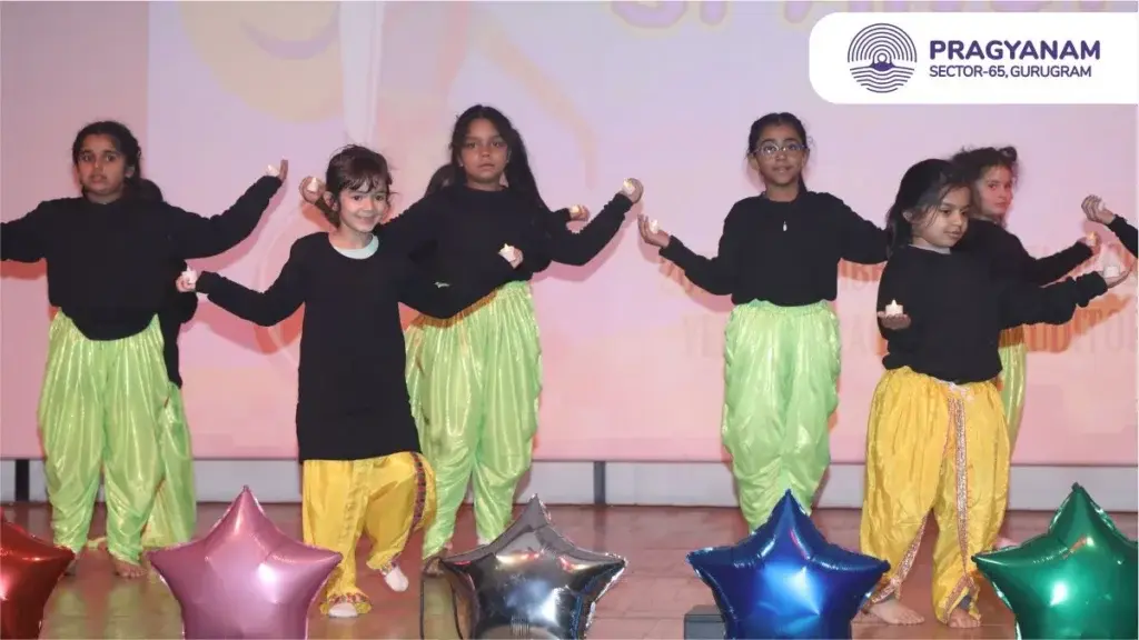A group of children performing a dance on stage