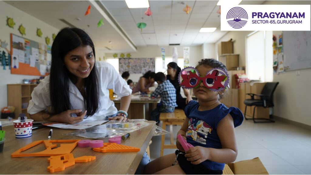 A Teacher Sitting with a Child A Teacher Sitting with a Child